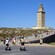 Tourists walking to and from a stone tower